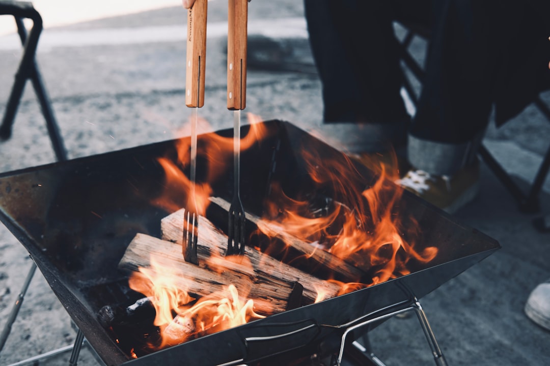 Barbecue à couvercle fermé dans un jardin, thermomètre visible sur le dôme.