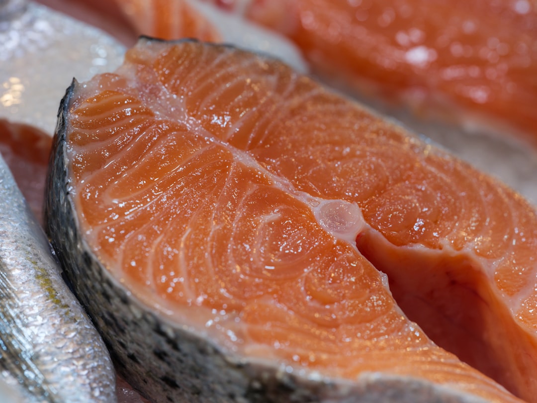 Darnes de saumon crues sur l'étal glacé d'un poissonnier, chair ferme et brillante